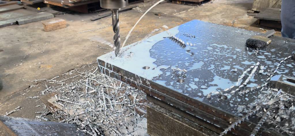 Drilling a base plate during crane fabrication at Toptek